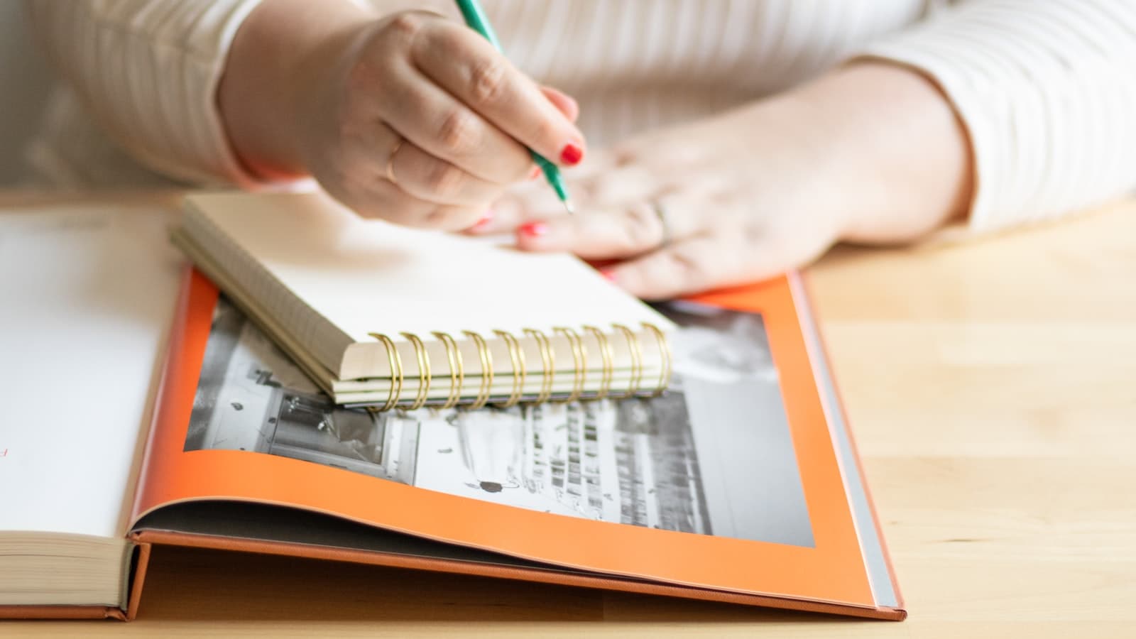 A person writing in a notebook