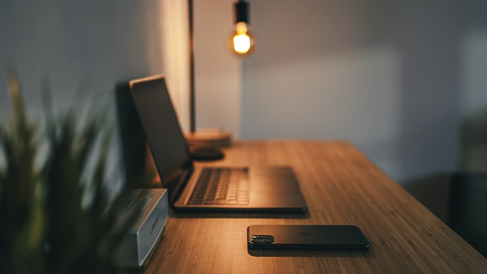 Black laptop computer on a brown wooden table