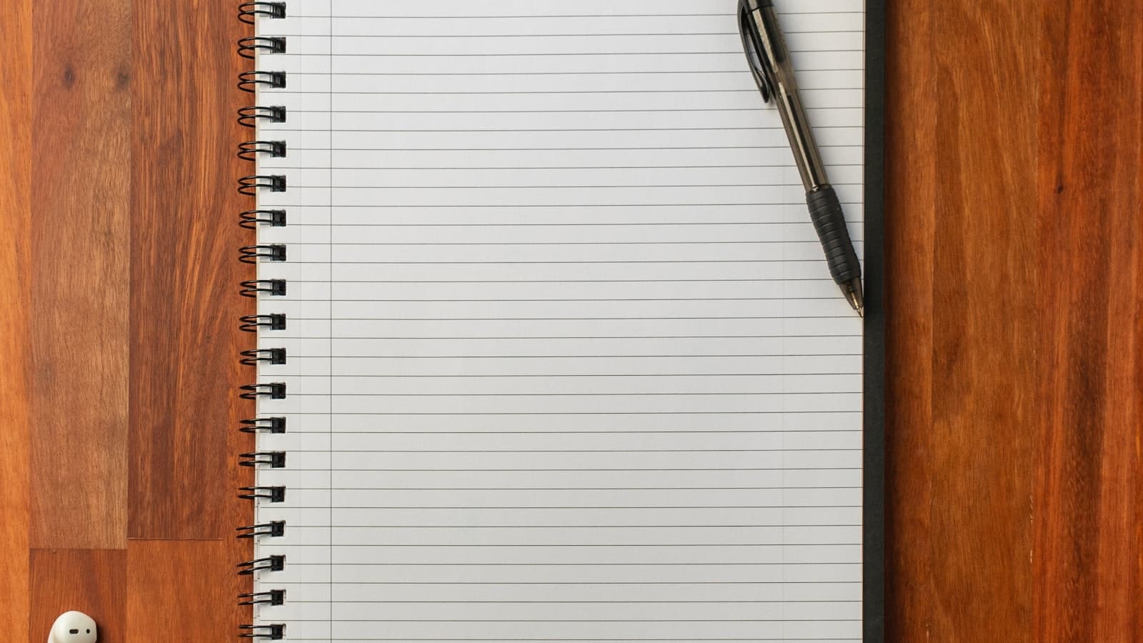 A pen on a notebook on a desk
